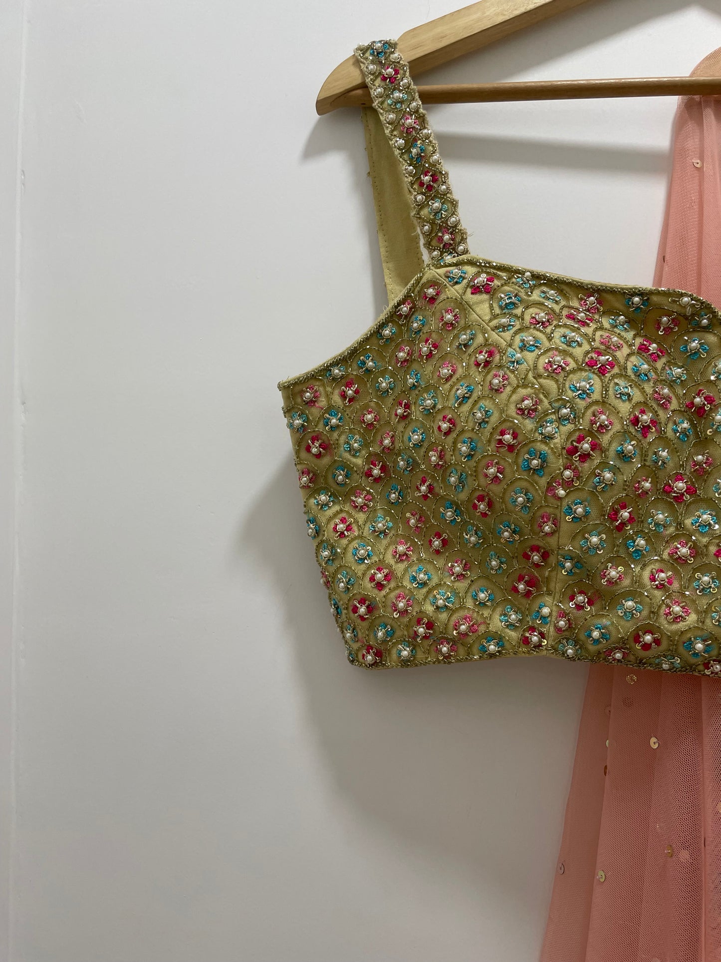 Colourful hand embroidered threadworm, pearl and gold blouse & dupatta with a high waisted floral printed chintz lehenga