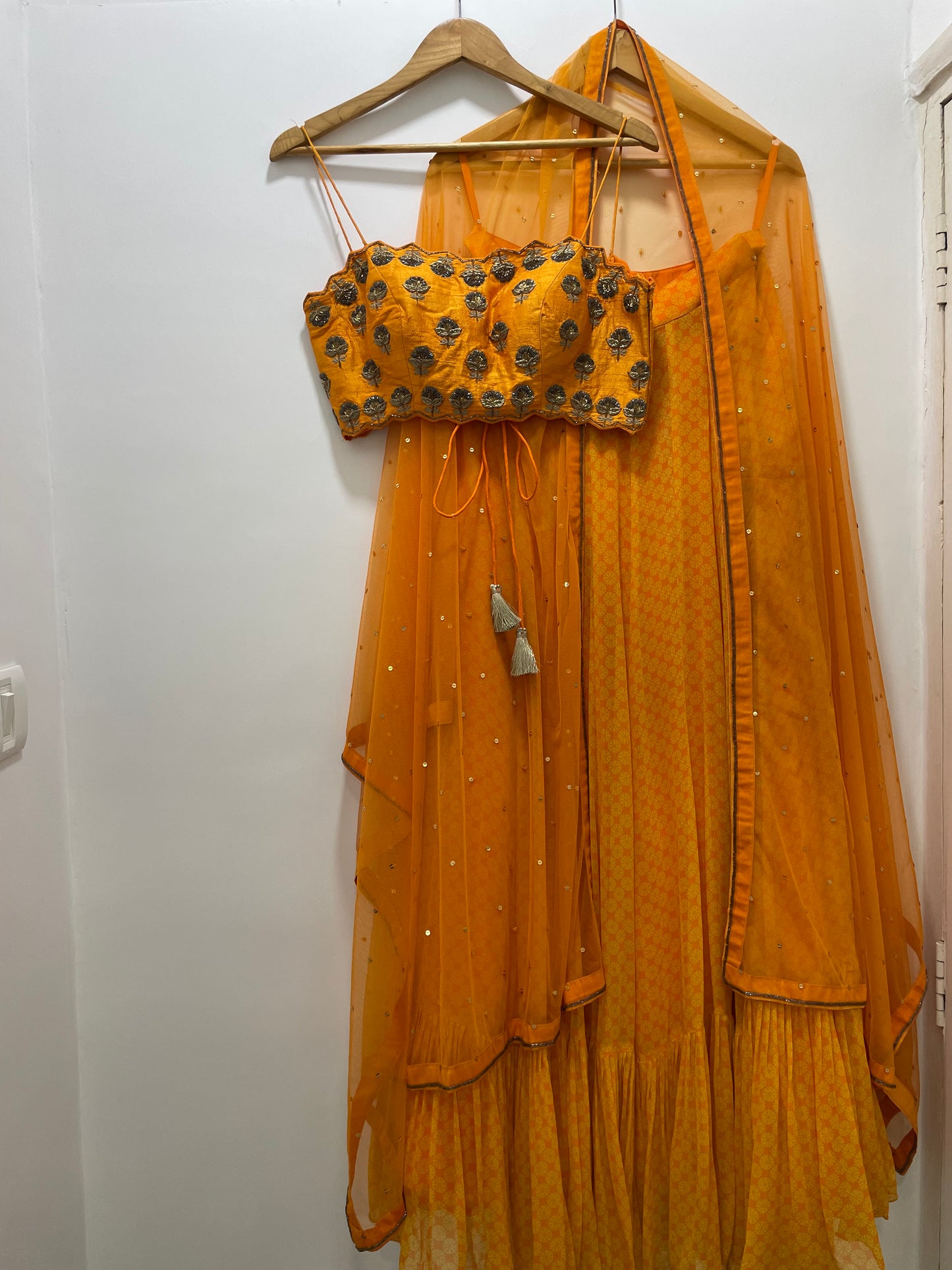 Hand embroidered orange blouse and dupatta with a high waisted geometric floral lehenga