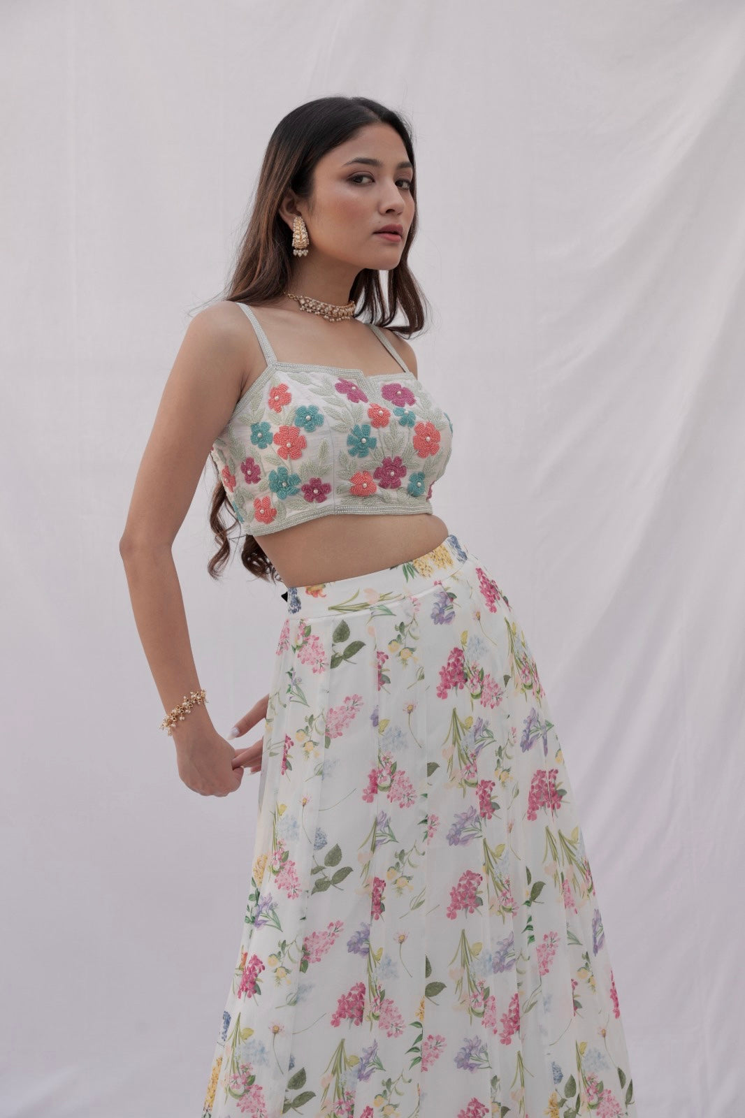 Ivory printed lehenga with a hand embroidered colourful blouse