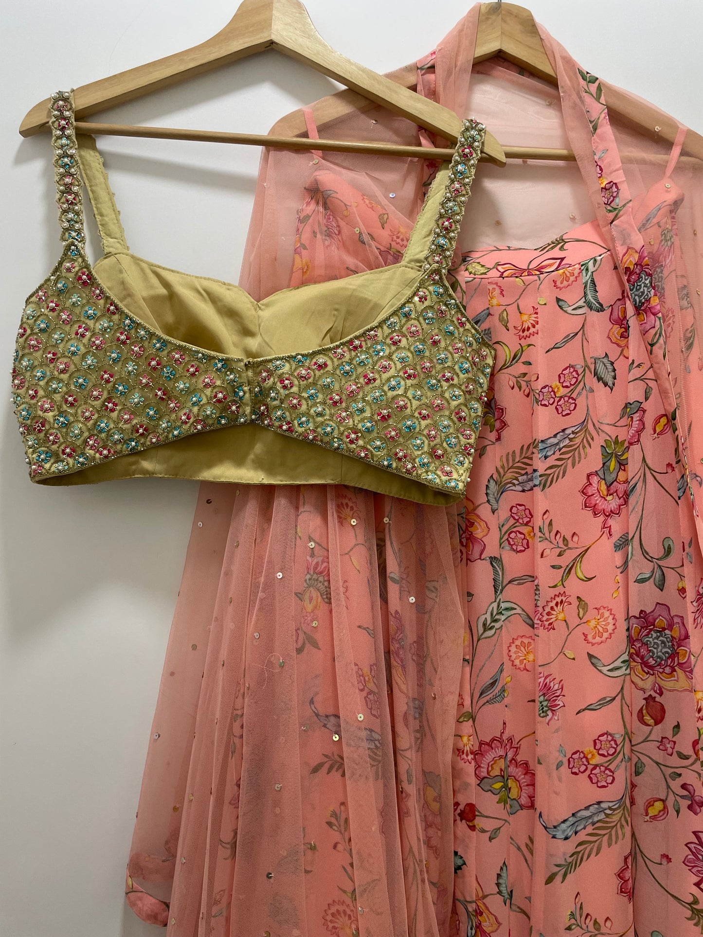 Colourful hand embroidered threadworm, pearl and gold blouse & dupatta with a high waisted floral printed chintz lehenga