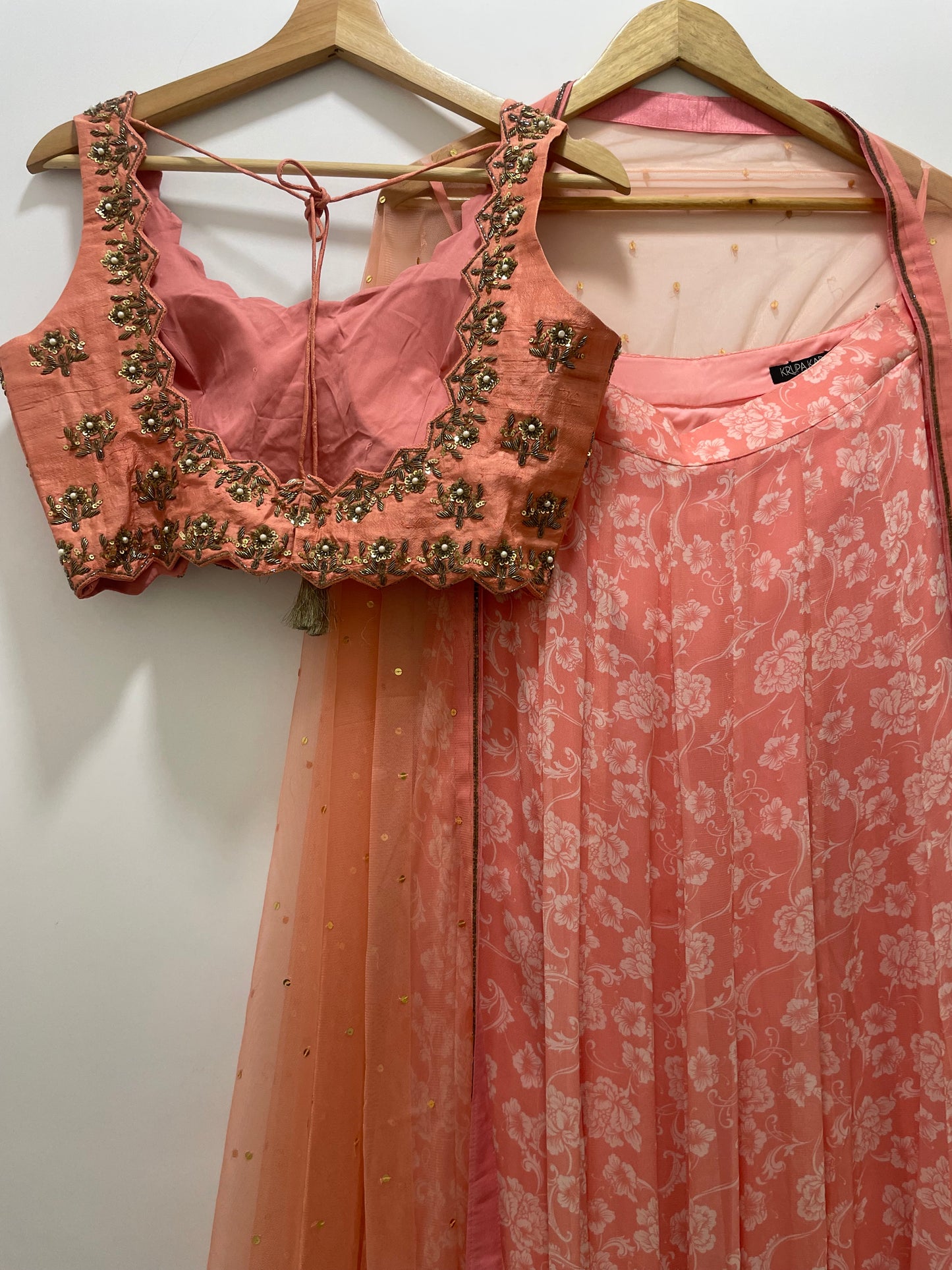 Baby pink hand embroidered blouse and dupatta with a high waisted floral printed lehenga