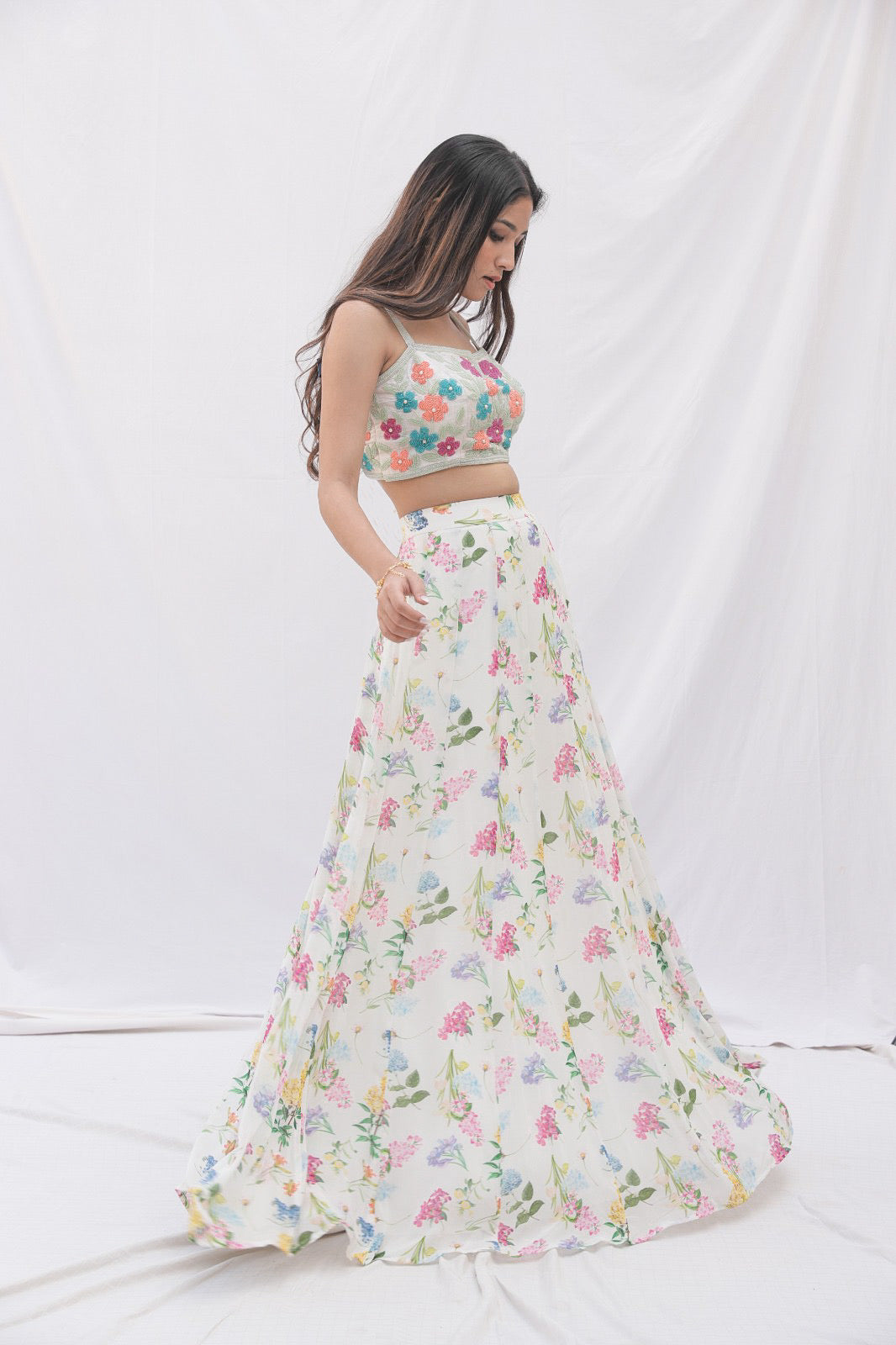 Ivory printed lehenga with a hand embroidered colourful blouse