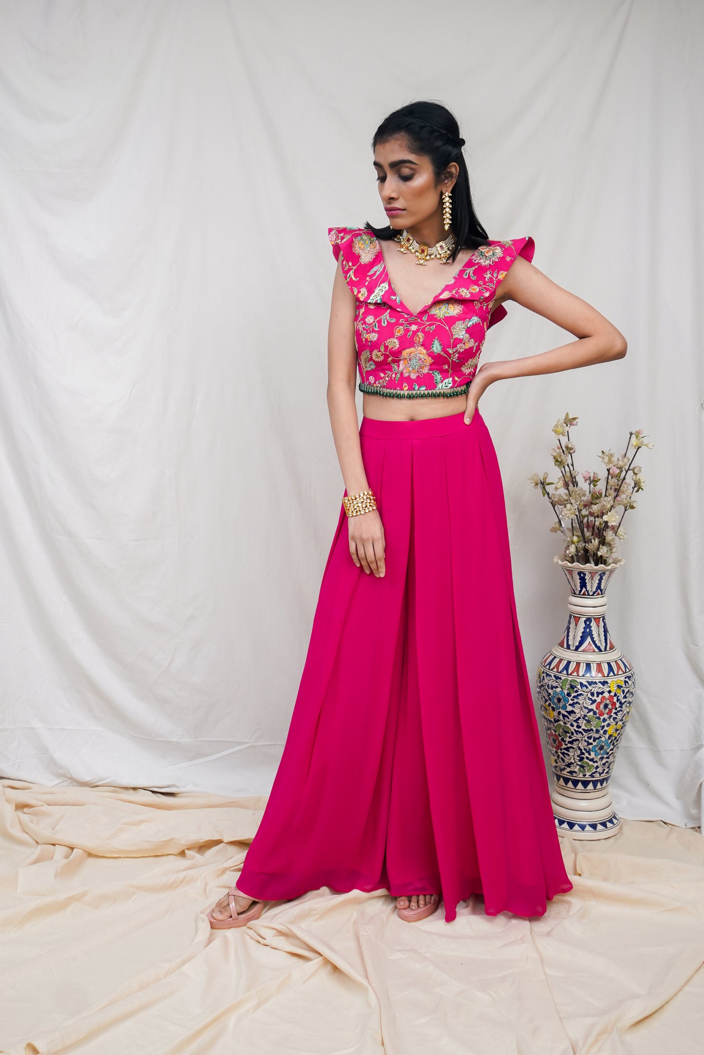Hot pink printed ruffle crop highlighted with intricate hand embroidery and high waisted palazzo pants