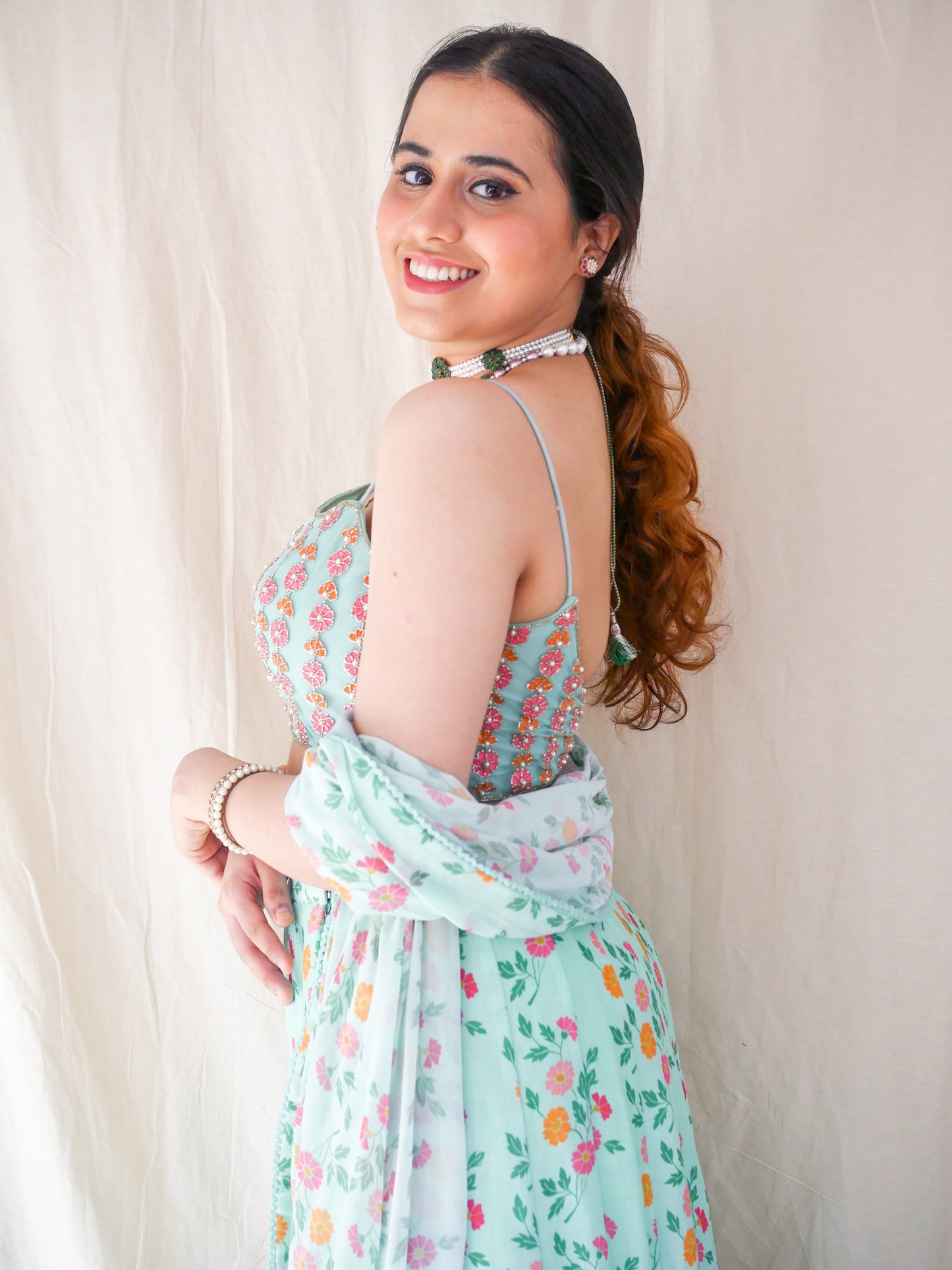 Hand embroidered ice blue blouse with a high waisted floral printed lehenga and dupatta
