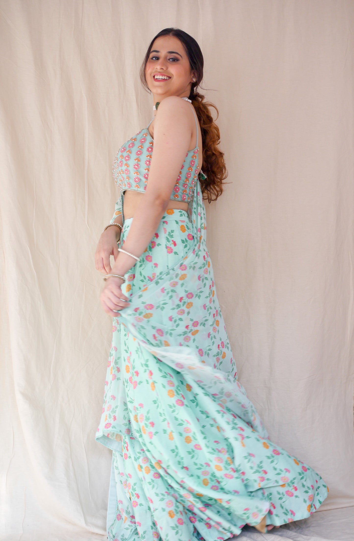 Hand embroidered ice blue blouse with a high waisted floral printed lehenga and dupatta