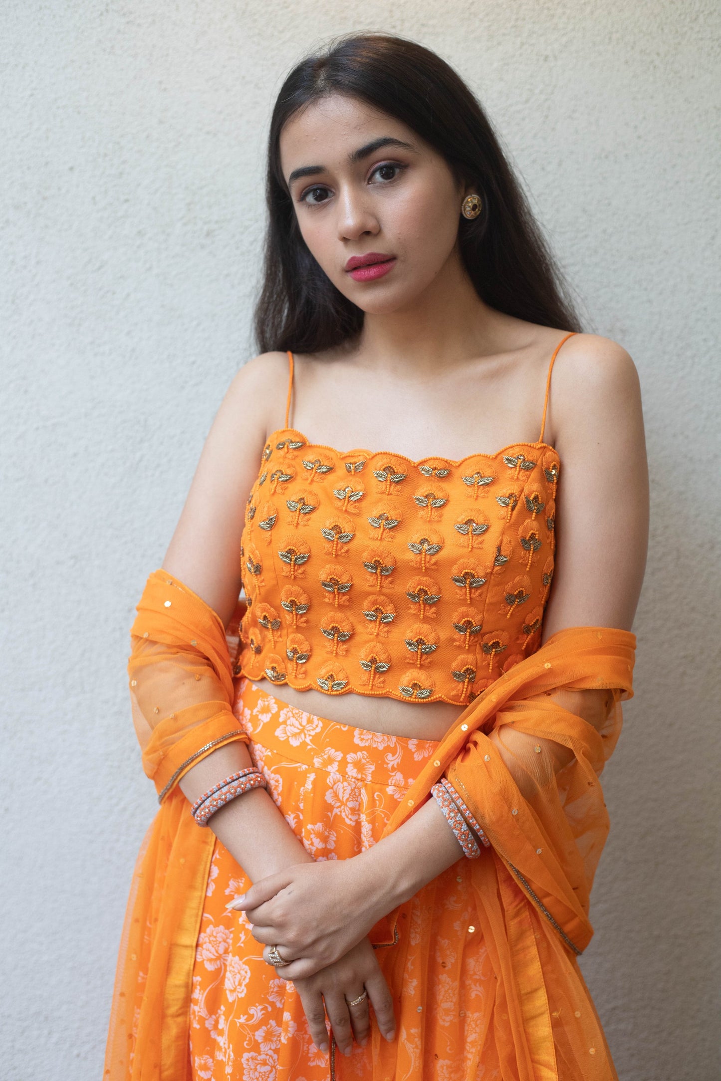 Sunshine orange floral printed skirt with a self embroidered blouse and dupatta