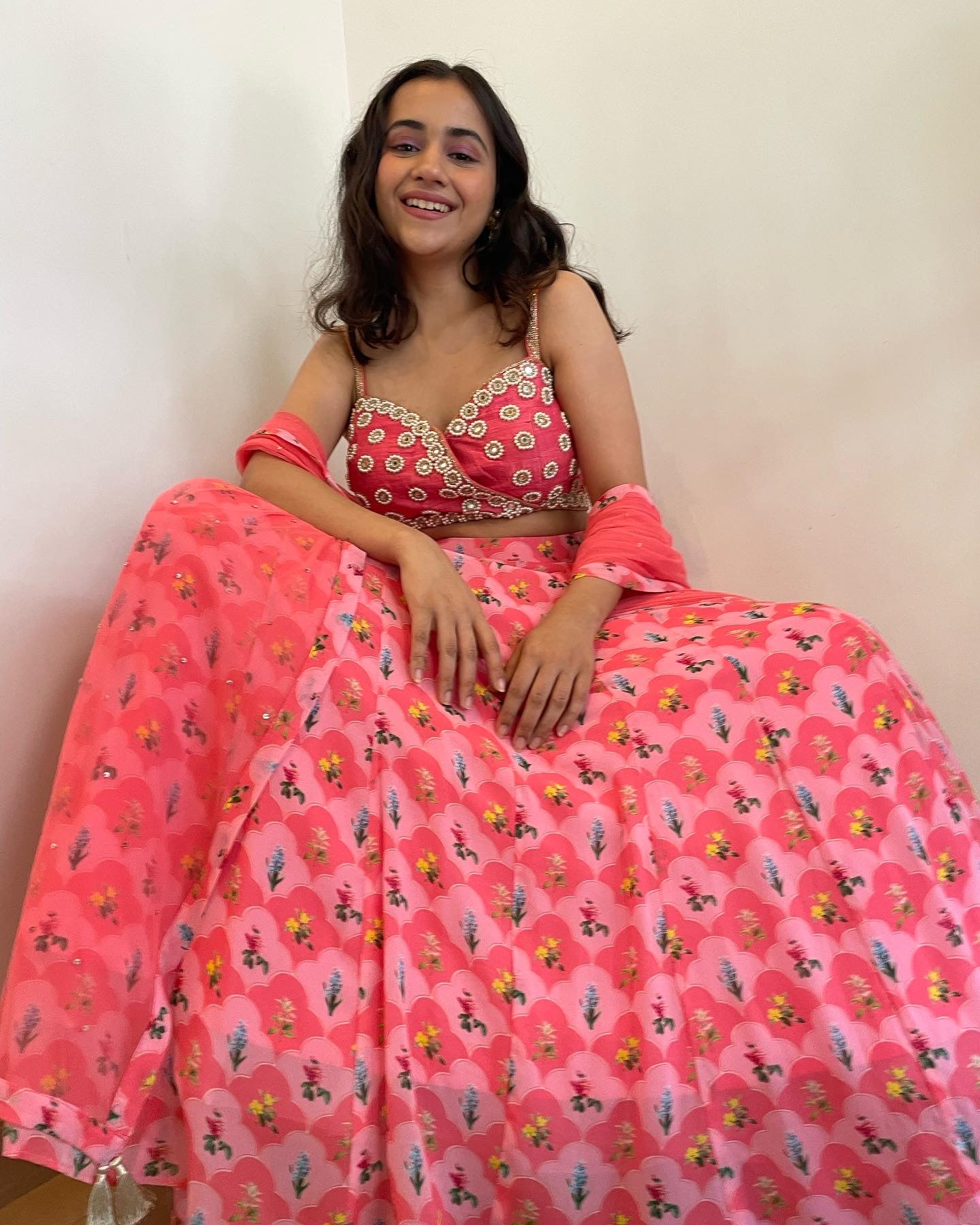 Hand embroidered pink panelled blouse with a floral printed lehenga and dupatta
