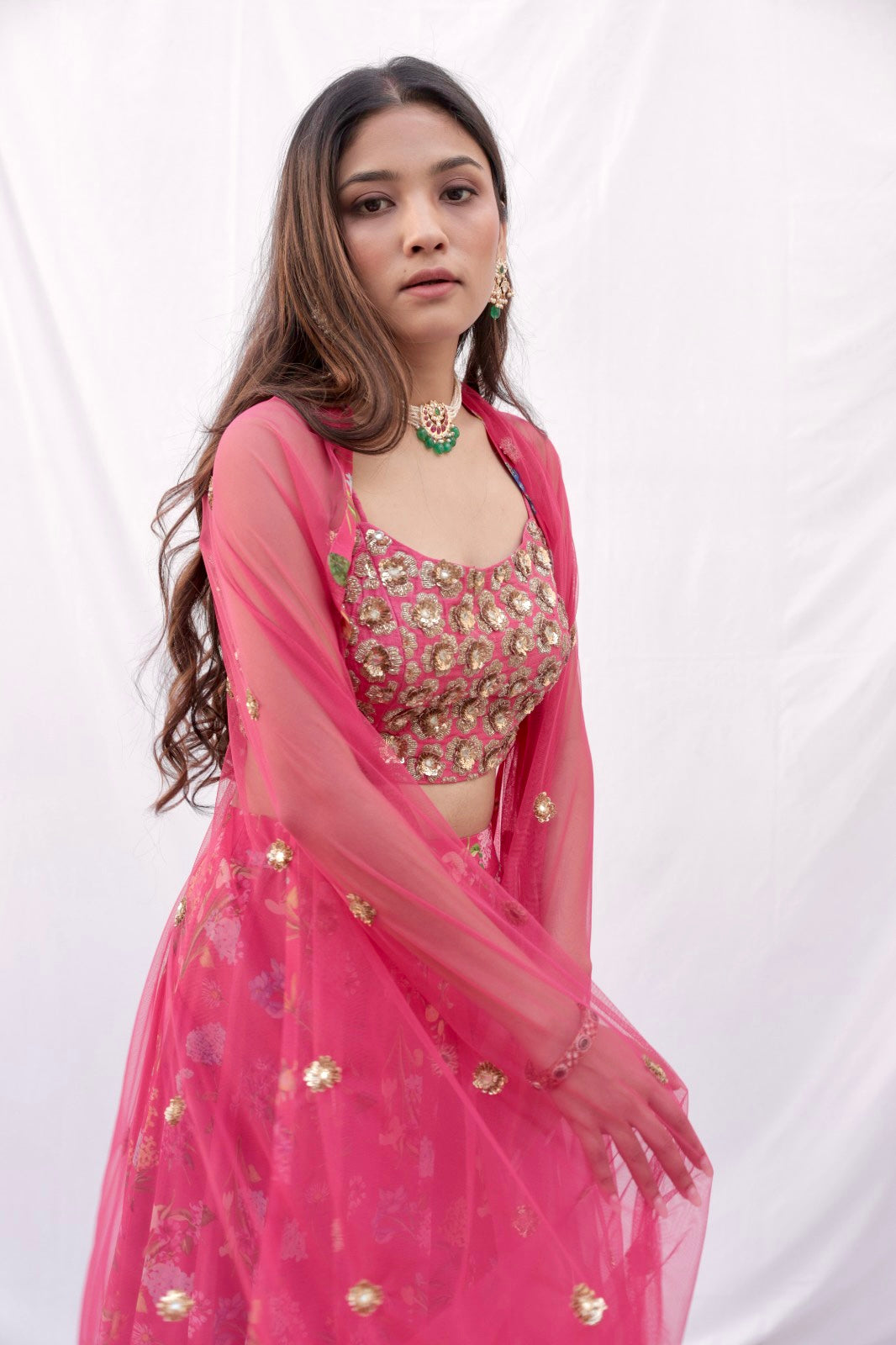 Hand embroidered carrot red 3D blouse and dupatta with a high waisted floral printed lehenga