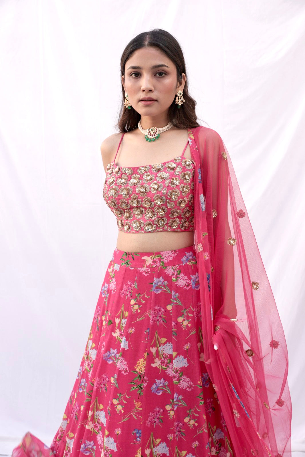Hand embroidered carrot red 3D blouse and dupatta with a high waisted floral printed lehenga