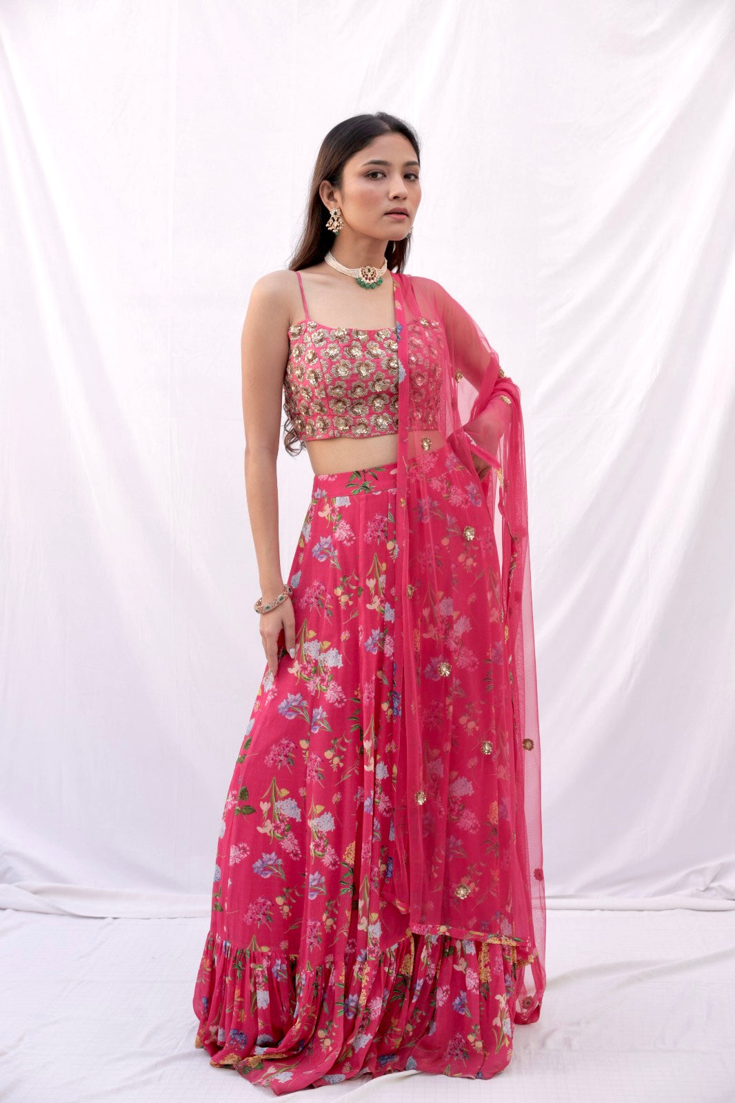 Hand embroidered carrot red 3D blouse and dupatta with a high waisted floral printed lehenga