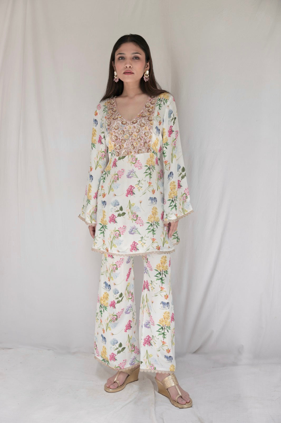 Ivory floral printed kurta with a hand embroidered yoke and flared pants