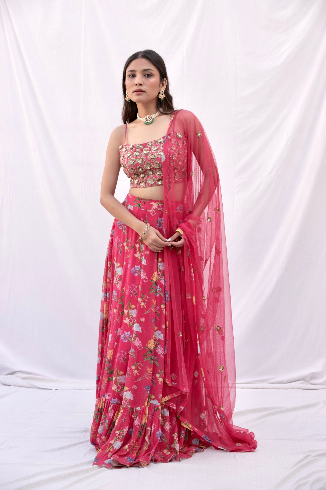 Hand embroidered carrot red 3D blouse and dupatta with a high waisted floral printed lehenga