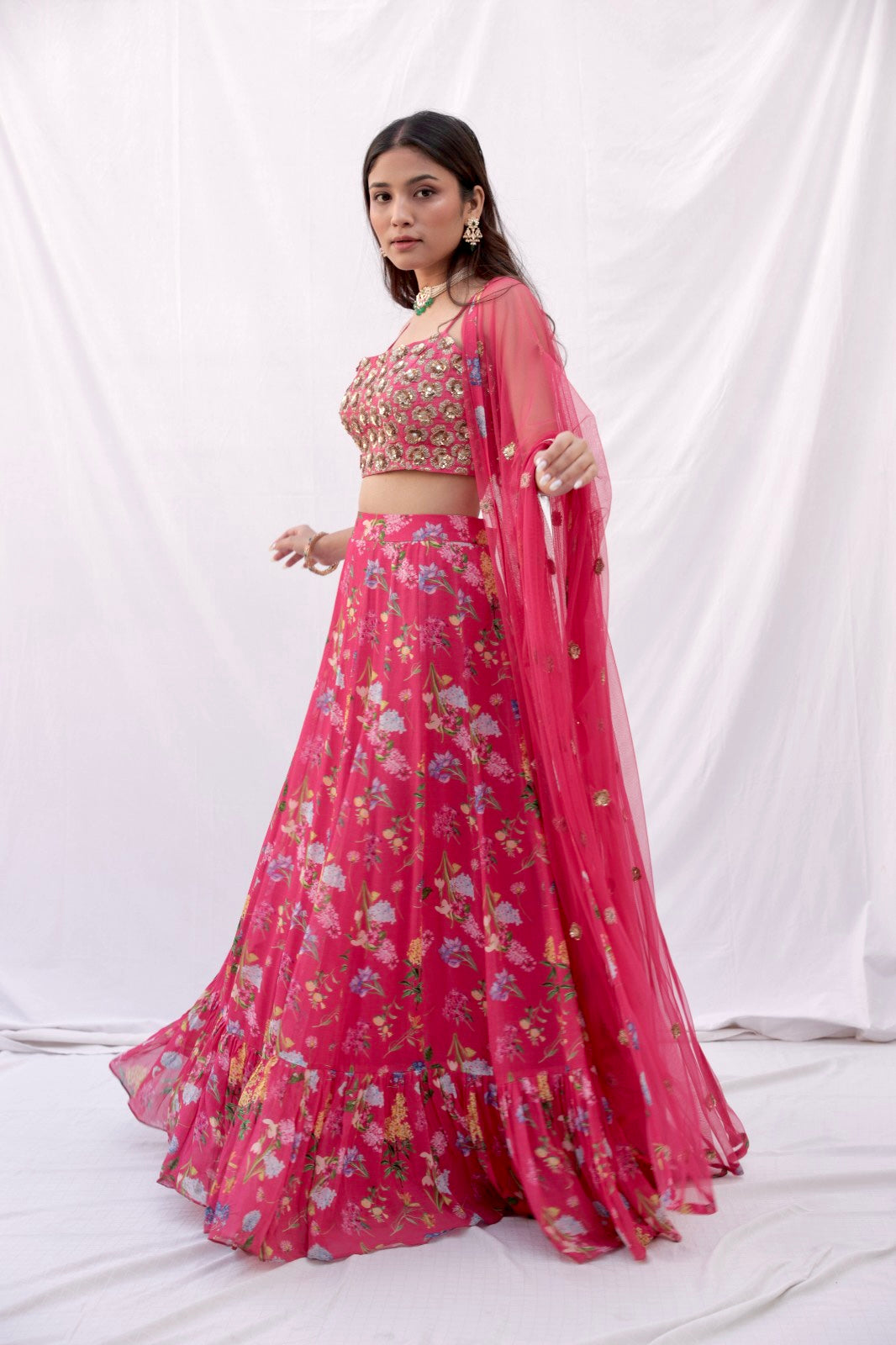 Hand embroidered carrot red 3D blouse and dupatta with a high waisted floral printed lehenga