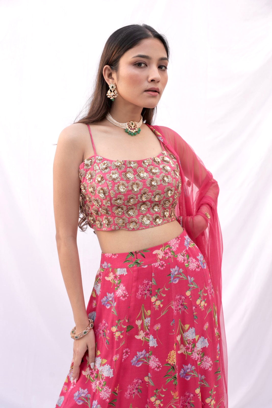 Hand embroidered carrot red 3D blouse and dupatta with a high waisted floral printed lehenga