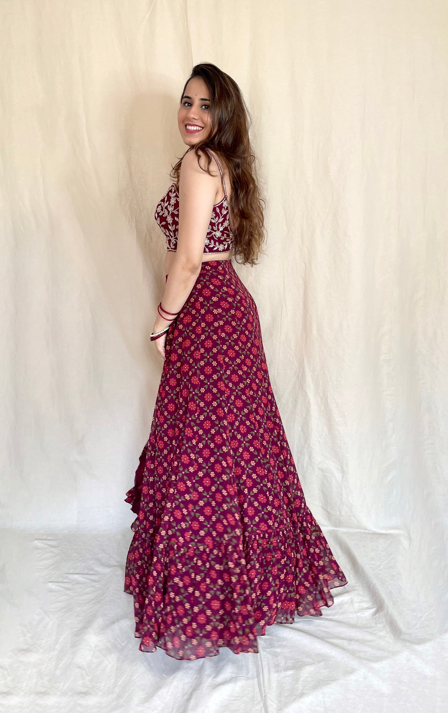 Wine floral printed lehenga with a hand embroidered strappy gold blouse and dupatta