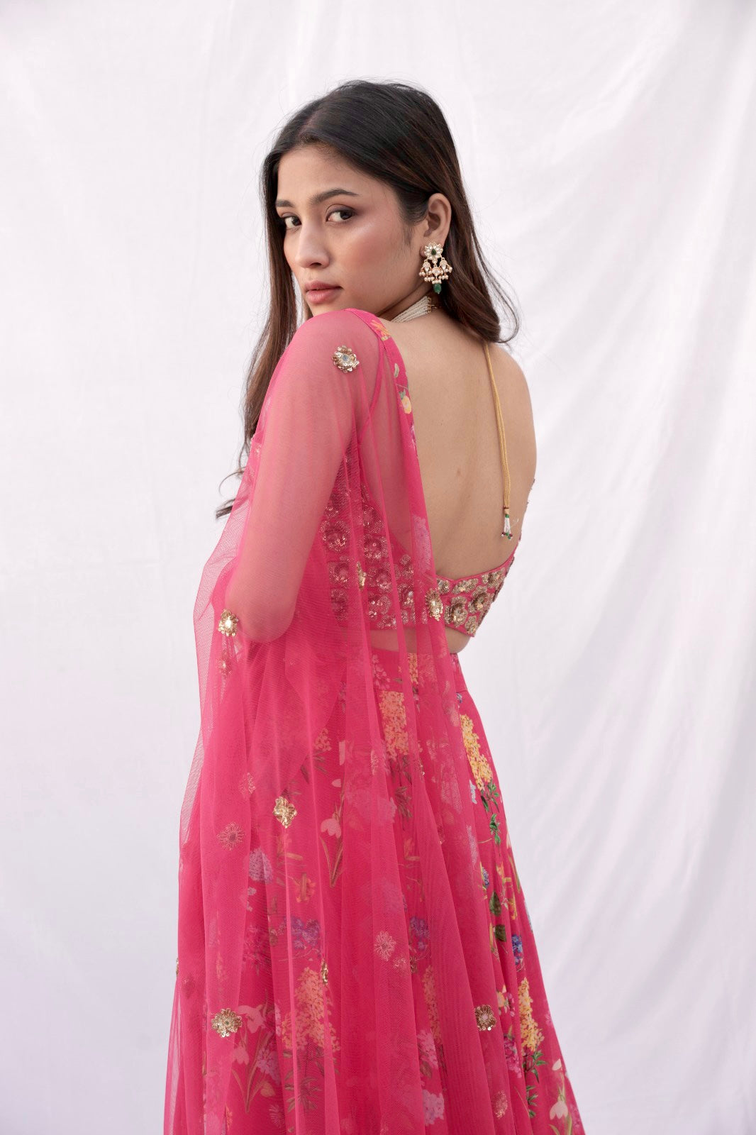 Hand embroidered carrot red 3D blouse and dupatta with a high waisted floral printed lehenga