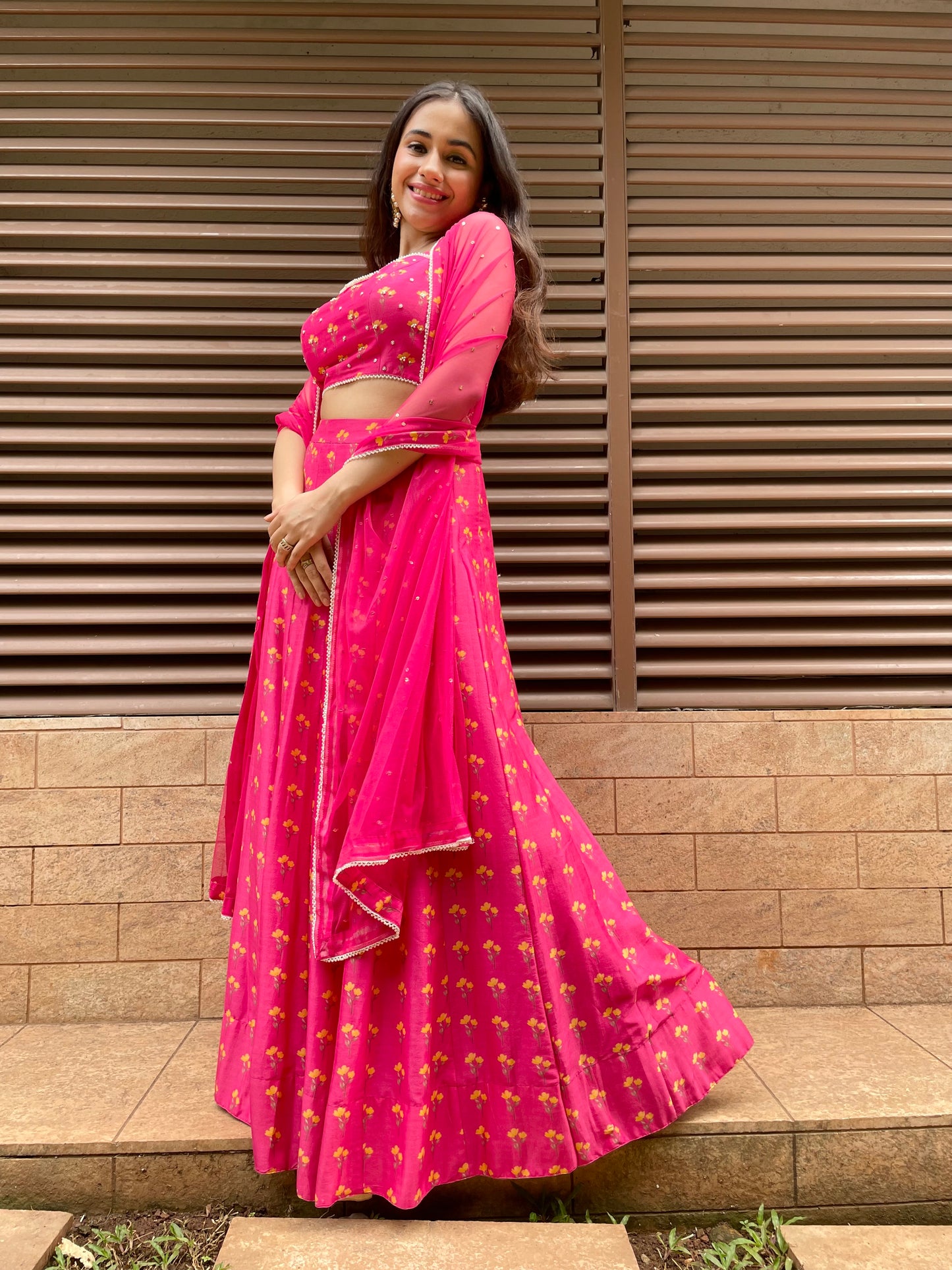 Hot pink floral printed lehenga with an embroidered blouse and dupatta