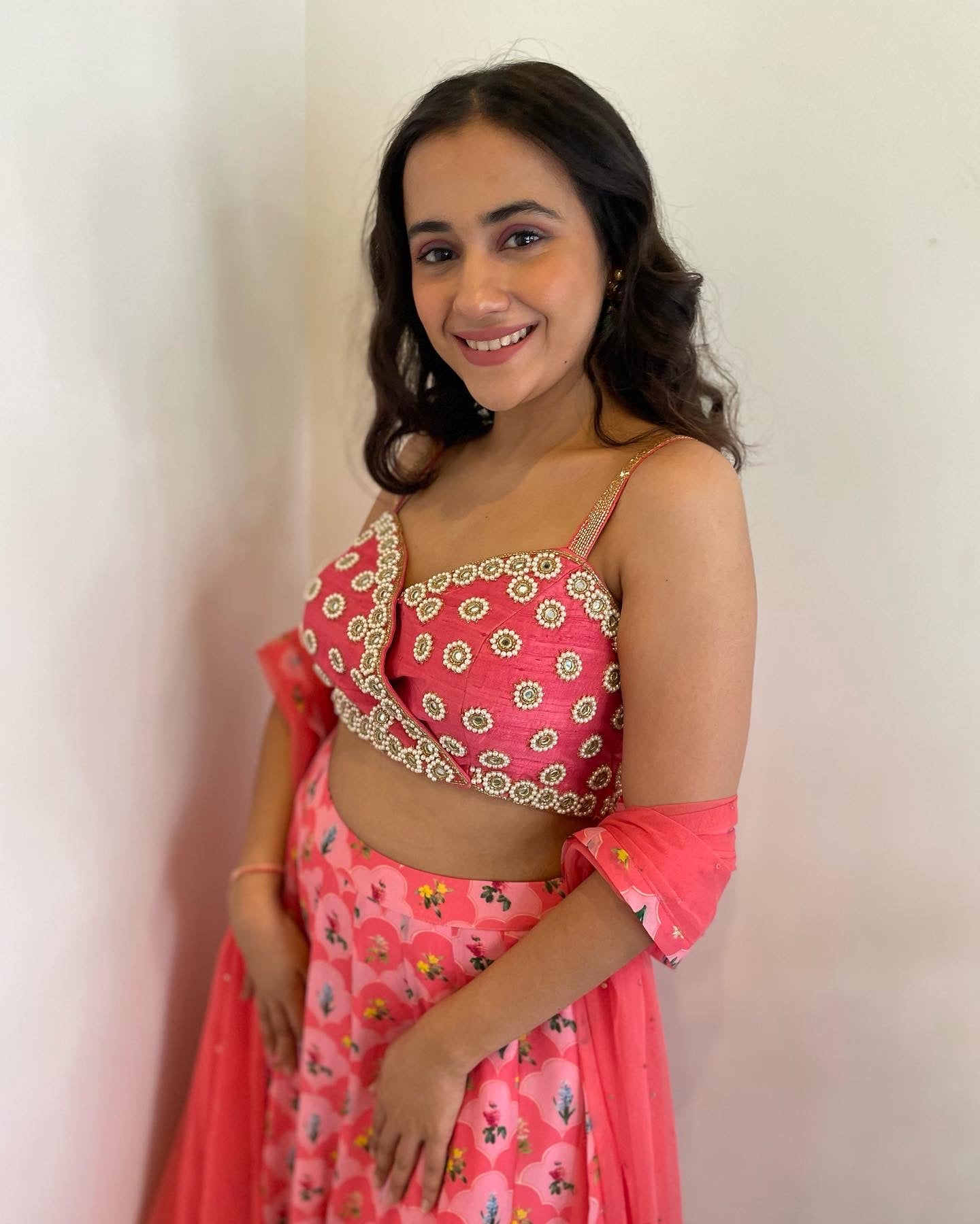 Hand embroidered pink panelled blouse with a floral printed lehenga and dupatta