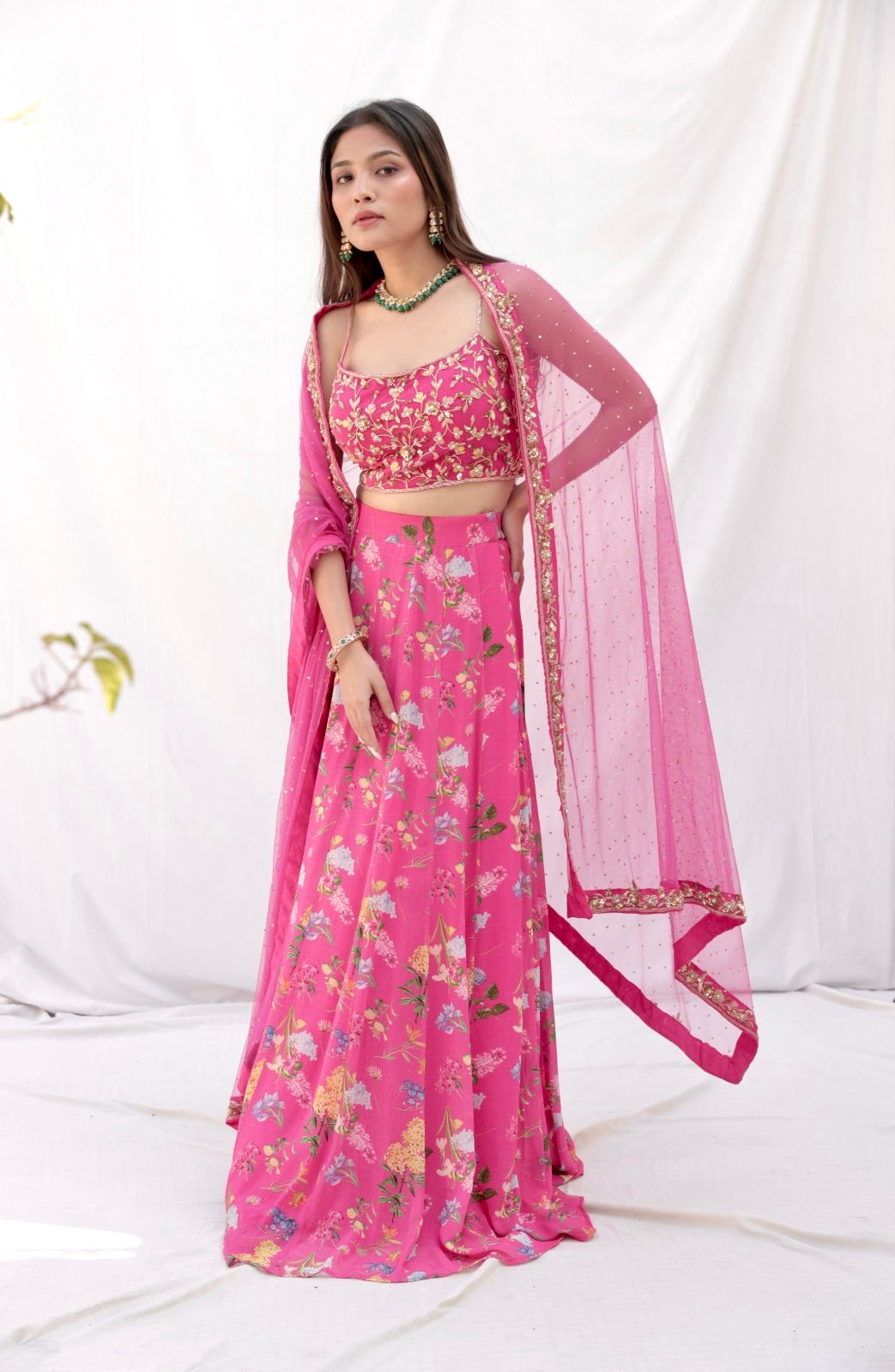 Deep pink floral printed lehenga with a hand embroidered blouse and heavy dupatta