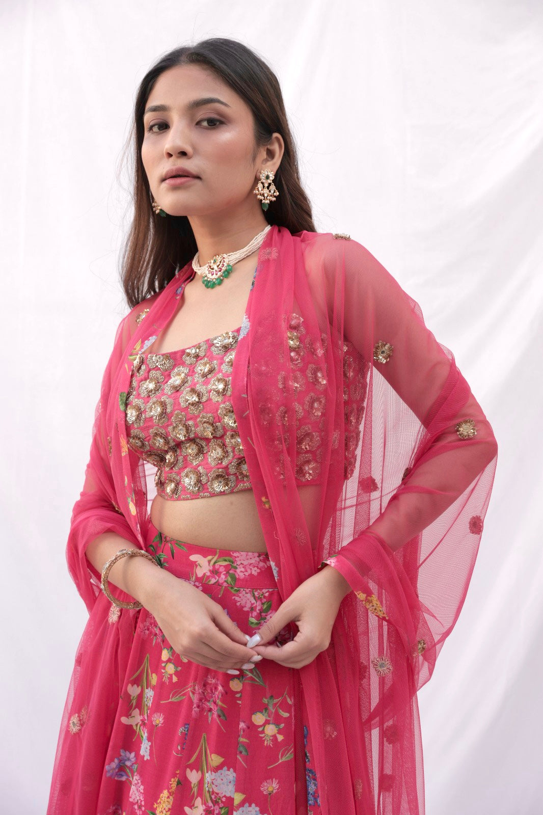 Hand embroidered carrot red 3D blouse and dupatta with a high waisted floral printed lehenga