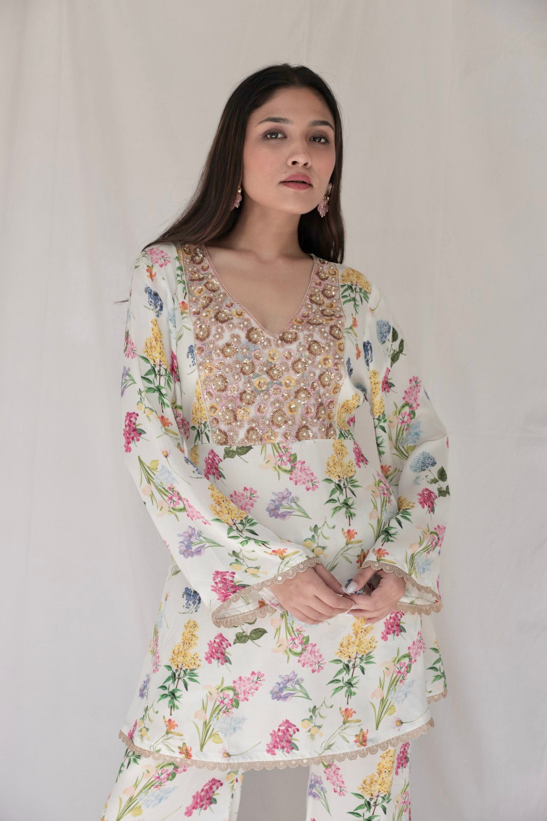 Ivory floral printed kurta with a hand embroidered yoke and flared pants