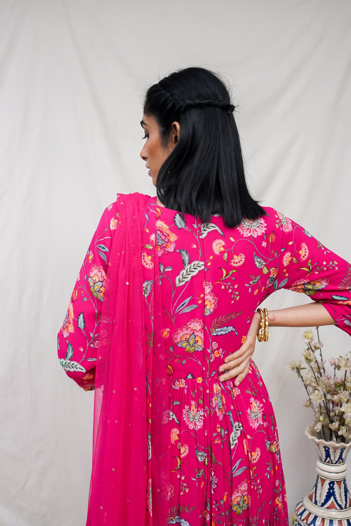 Rani pink layered anarkali set with an embroidered yoke and dupatta