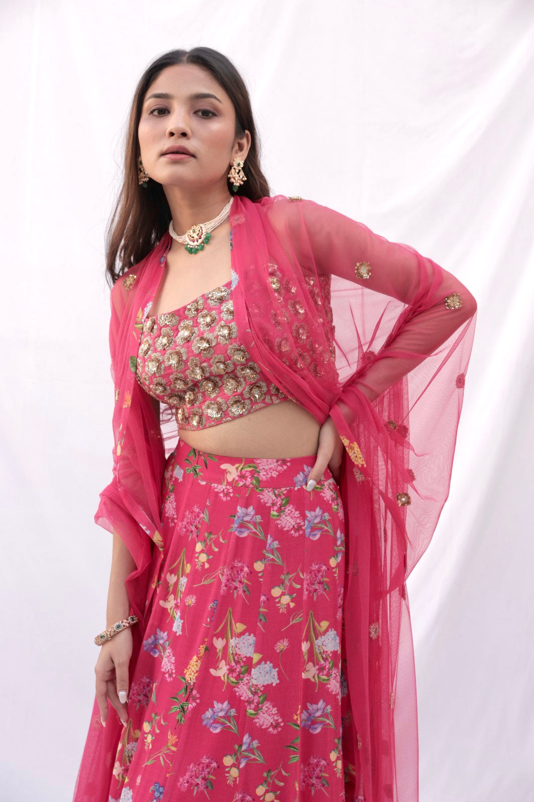 Hand embroidered carrot red 3D blouse and dupatta with a high waisted floral printed lehenga