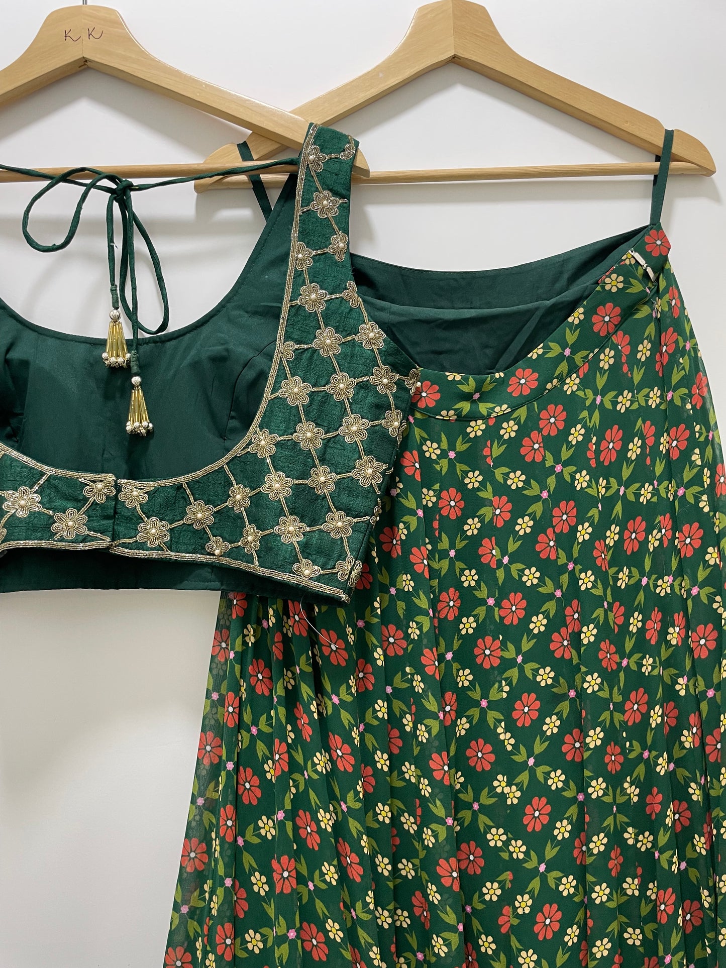 Bottle green hand embroidered criss cross blouse and dupatta with a high waisted floral printed lehenga