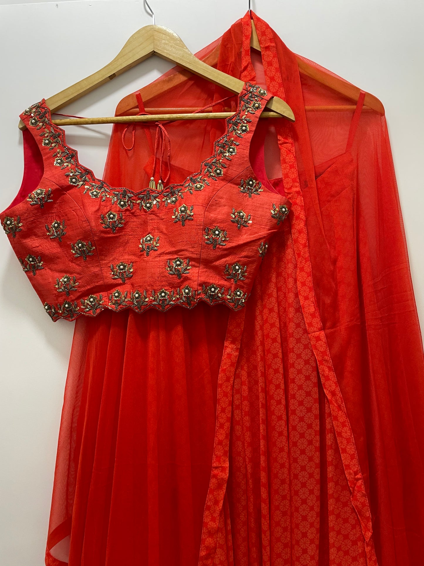 Deep red hand embroidered sleeveless blouse with a high waisted geometric floral lehenga & dupatta