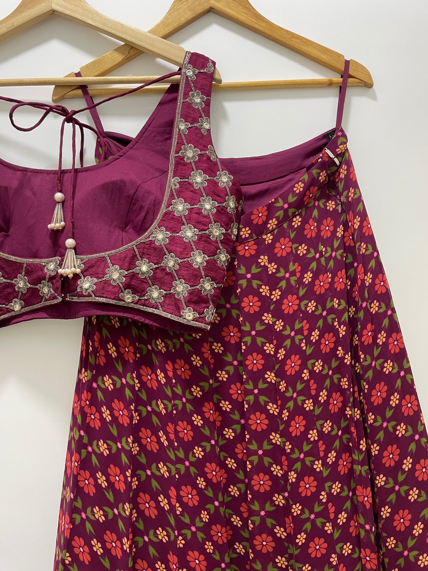 Hand embroidered wine criss cross blouse and dupatta with a high waisted floral printed lehenga