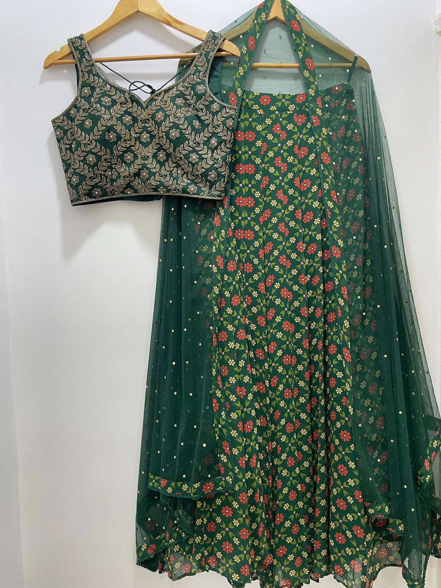 Bottle green hand embroidered gold blouse and dupatta with a high waisted floral printed lehenga