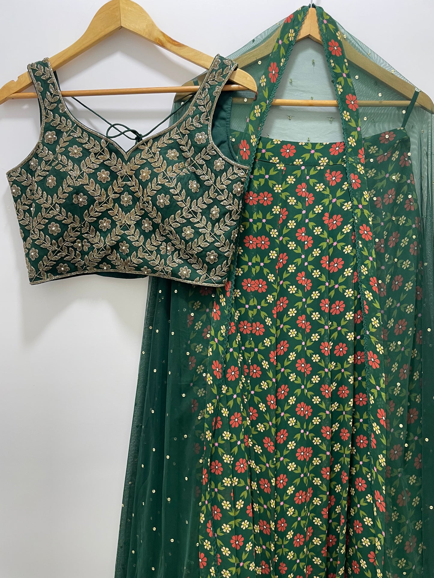 Bottle green hand embroidered gold blouse and dupatta with a high waisted floral printed lehenga