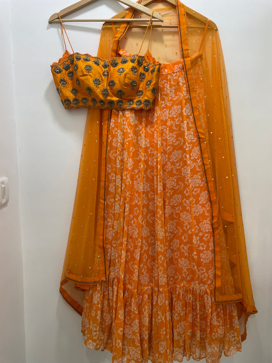 Hand embroidered orange blouse and dupatta with a high waisted floral printed lehenga