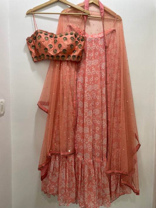 Baby pink hand embroidered strappy blouse and dupatta with a high waisted floral printed lehenga