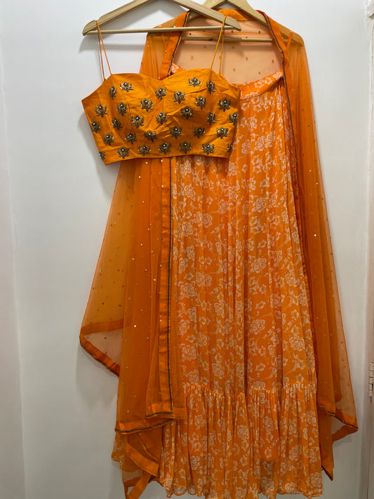 Hand embroidered orange blouse and dupatta with a high waisted floral printed lehenga