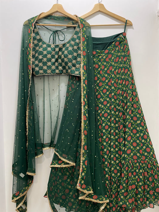 Bottle green hand embroidered criss cross blouse and dupatta with a high waisted floral printed lehenga