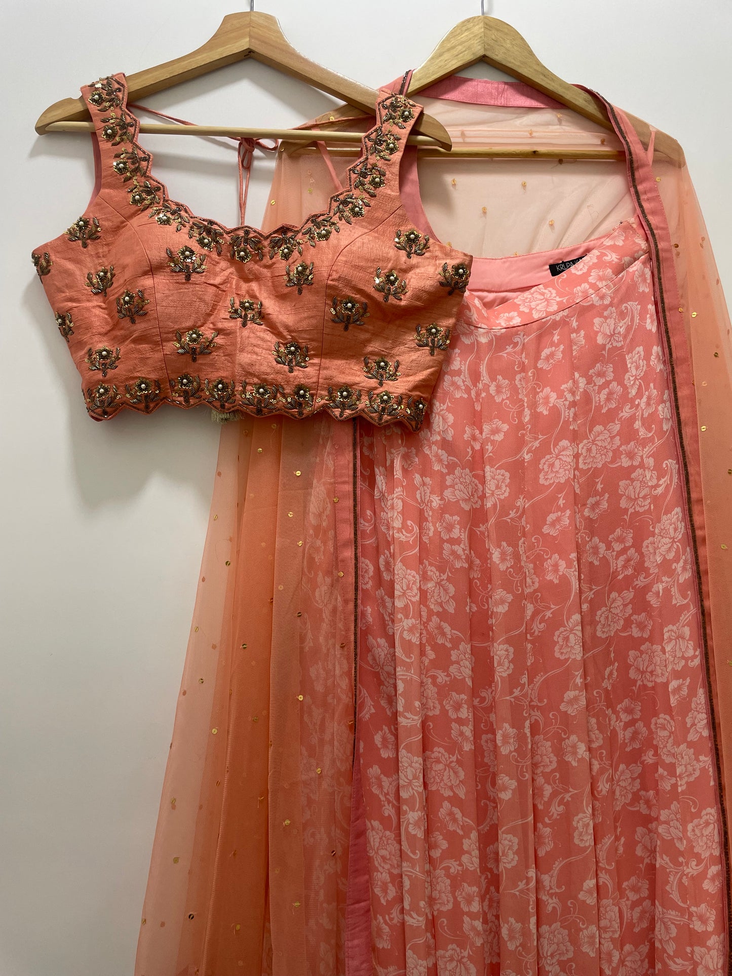 Baby pink hand embroidered blouse and dupatta with a high waisted floral printed lehenga