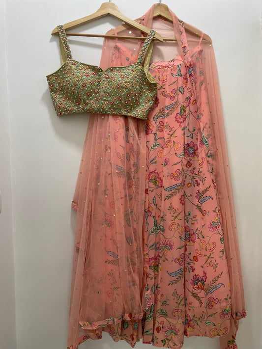 Colourful hand embroidered threadworm, pearl and gold blouse & dupatta with a high waisted floral printed chintz lehenga