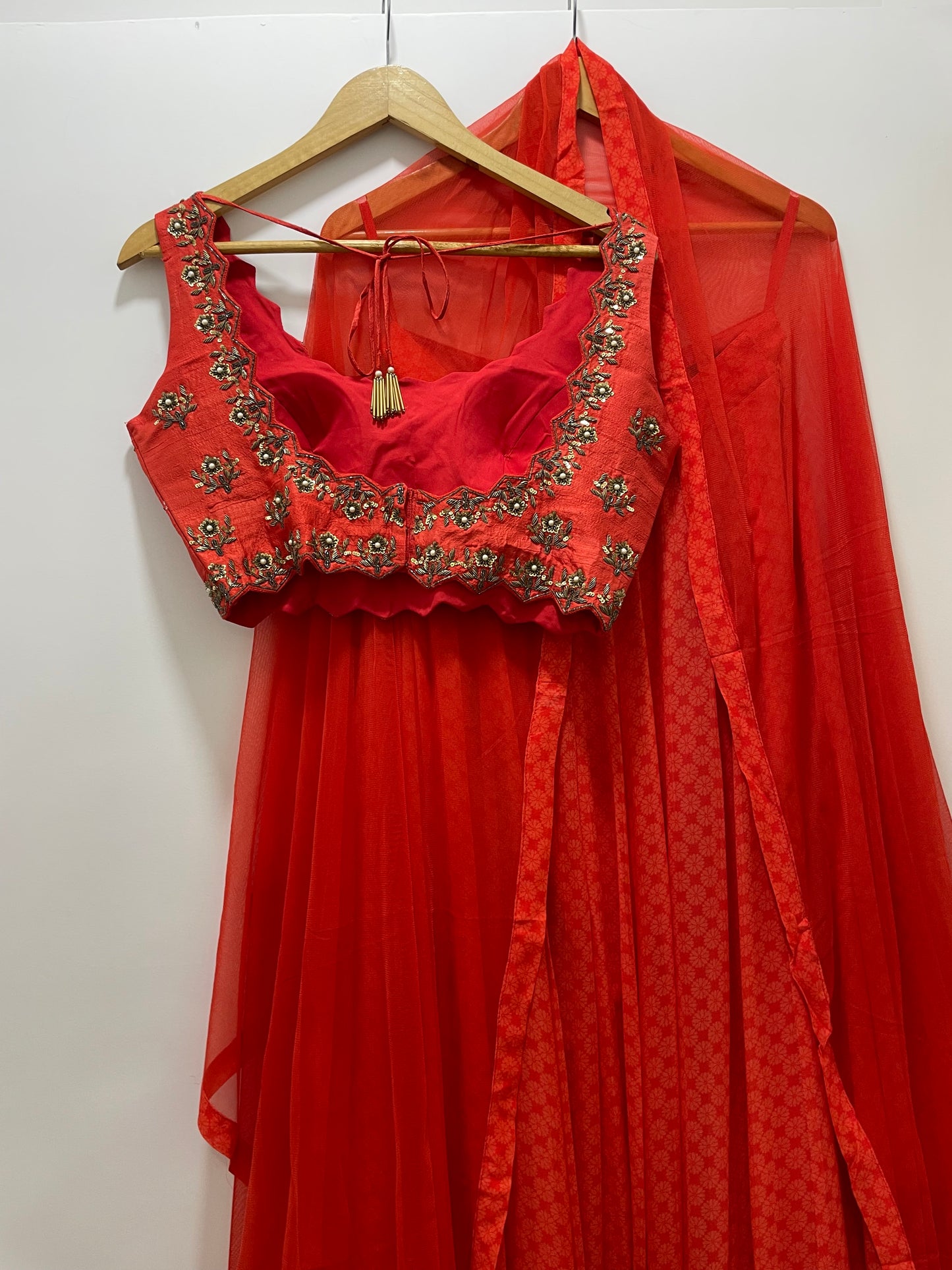 Deep red hand embroidered sleeveless blouse with a high waisted geometric floral lehenga & dupatta