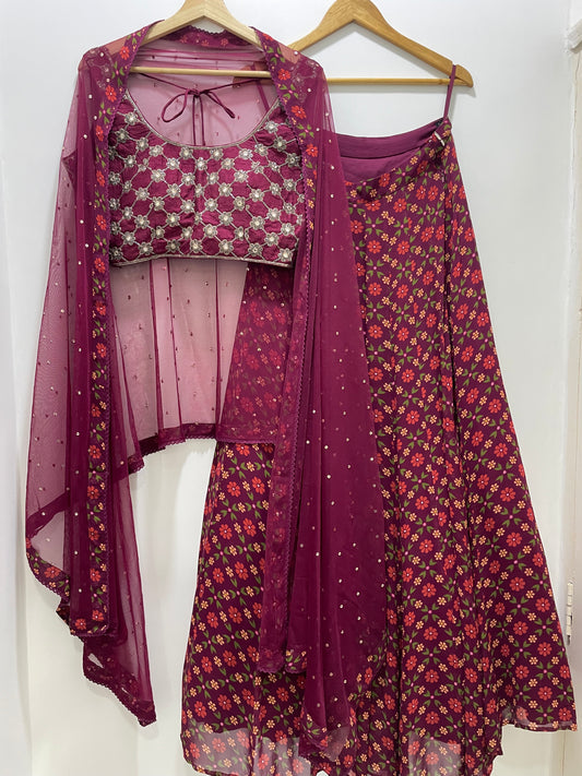 Hand embroidered wine criss cross blouse and dupatta with a high waisted floral printed lehenga