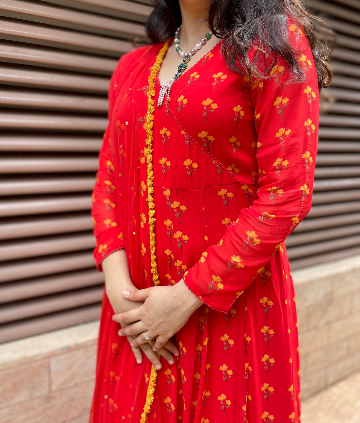 Red floral printed anarkali with an embroidered dupatta and fringe detailing
