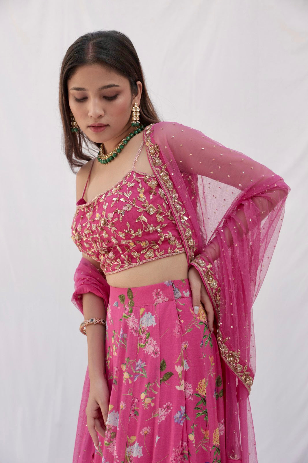 Deep pink floral printed lehenga with a hand embroidered blouse and heavy dupatta