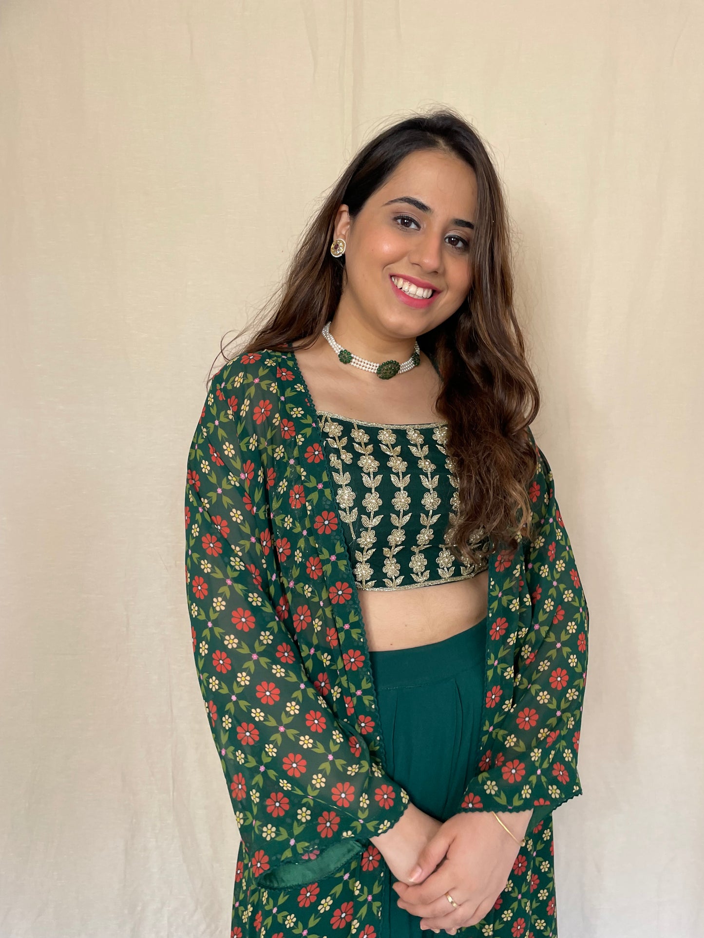 Bottle green linear hand embroidered blouse, palazzos and a floral printed cape