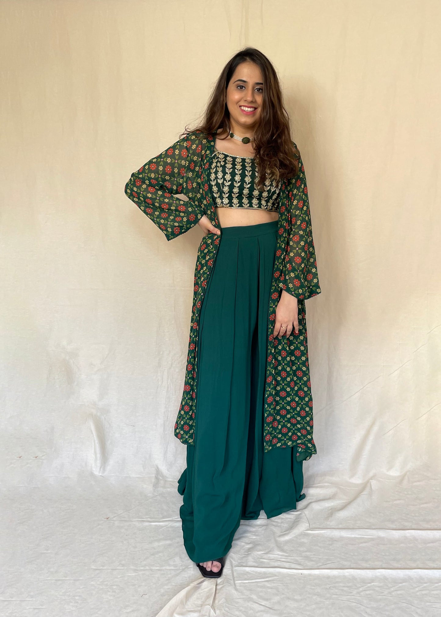 Bottle green linear hand embroidered blouse, palazzos and a floral printed cape