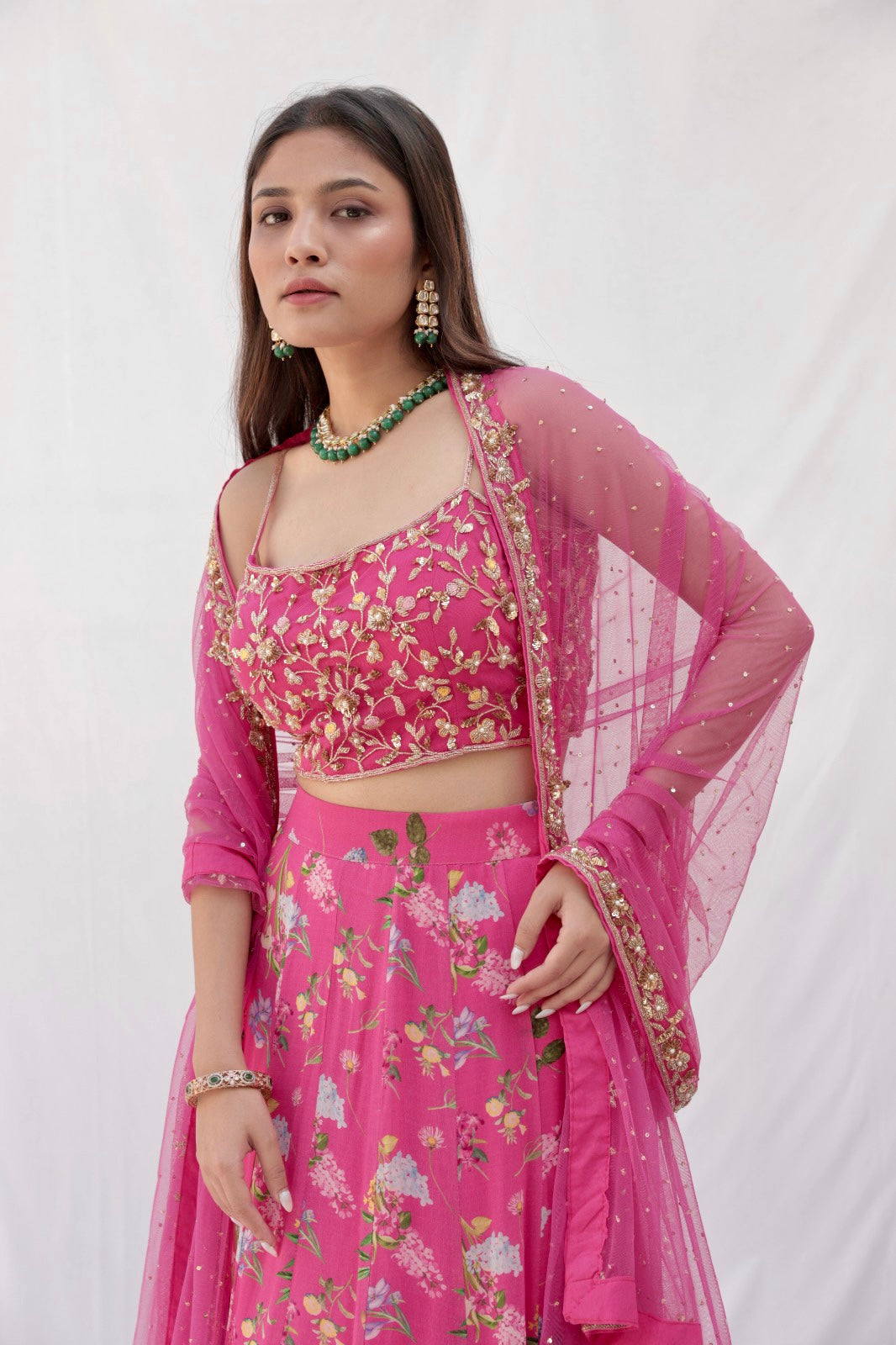 Deep pink floral printed lehenga with a hand embroidered blouse and heavy dupatta